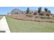 Green side yard featuring a mulched garden area, sidewalk and privacy fence at 609 Francis Ave, Peachtree City, GA 30269