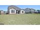 Spacious backyard featuring a well-maintained lawn and black fence for outdoor enjoyment and privacy at 609 Francis Ave, Peachtree City, GA 30269