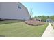 Expansive backyard featuring a well-manicured lawn and a freshly-mulched garden bed at 609 Francis Ave, Peachtree City, GA 30269