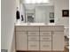 Bathroom with white double vanity, framed mirror and framed decor on gray wall at 609 Francis Ave, Peachtree City, GA 30269