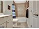 Well-lit bathroom featuring a tub with a tiled surround, a vanity, and decor at 609 Francis Ave, Peachtree City, GA 30269