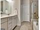 Bright bathroom with a white vanity, decorative mirror, tiled floors, and glass shower at 609 Francis Ave, Peachtree City, GA 30269