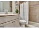 Modern bathroom with a shower featuring glass doors, light-toned cabinets, and neutral decor at 609 Francis Ave, Peachtree City, GA 30269