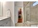 Open doorway leading to walk-in closet and glass shower with tub combo in bathroom at 609 Francis Ave, Peachtree City, GA 30269