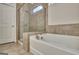 Glass shower and tub combo with tile surround in a bright bathroom at 609 Francis Ave, Peachtree City, GA 30269