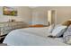 This bedroom has a modern dresser, tv, and a cozy bed with pillows and a mustard throw at 609 Francis Ave, Peachtree City, GA 30269