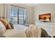 Bright bedroom featuring a TV and window with a street view, plus decorative pillows and throws at 609 Francis Ave, Peachtree City, GA 30269