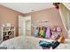 Cozy bedroom featuring a princess-themed dress-up area and rainbow comforter at 609 Francis Ave, Peachtree City, GA 30269