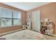 Bedroom featuring pink walls, a window view, and a toy kitchen set at 609 Francis Ave, Peachtree City, GA 30269
