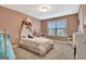 Bedroom with a white bed and a pink wall, featuring a window view at 609 Francis Ave, Peachtree City, GA 30269