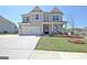 Charming two-story home with a well-manicured lawn, a two-car garage, and a welcoming front porch at 609 Francis Ave, Peachtree City, GA 30269