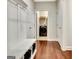 Hallway with coat rack and cubbies leads to the laundry room with modern washer and dryer at 609 Francis Ave, Peachtree City, GA 30269