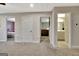 Hallway with carpeted floor leads to a bedroom and a bathroom with double vanity at 609 Francis Ave, Peachtree City, GA 30269