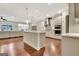 Open concept kitchen with island, stainless steel appliances and hardwood floors at 609 Francis Ave, Peachtree City, GA 30269