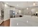 Kitchen with a large island with white countertop, stainless steel appliances, and hardwood floors at 609 Francis Ave, Peachtree City, GA 30269