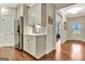 Bright kitchen with stainless steel refrigerator, tile backsplash, and wood flooring at 609 Francis Ave, Peachtree City, GA 30269