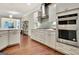 Bright kitchen with stainless steel appliances, modern range hood and hardwood floors at 609 Francis Ave, Peachtree City, GA 30269