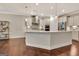 Bright kitchen with a large island, modern pendant lighting, and hardwood floors at 609 Francis Ave, Peachtree City, GA 30269