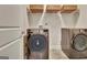 Modern laundry room with high-efficiency washer and dryer plus extra basket storage at 609 Francis Ave, Peachtree City, GA 30269