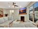Cozy living room featuring a fireplace, ceiling fan, and comfortable sectional sofa for relaxation at 609 Francis Ave, Peachtree City, GA 30269