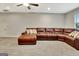 Comfortable living room with a large, inviting leather sectional sofa and a ceiling fan at 609 Francis Ave, Peachtree City, GA 30269