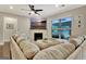 Inviting living room with a modern fireplace, neutral decor, and a large sectional sofa for gatherings at 609 Francis Ave, Peachtree City, GA 30269