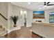 Elegant living room featuring hardwood floors, a modern fireplace, and seamless flow to other spaces at 609 Francis Ave, Peachtree City, GA 30269
