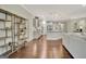 Open-concept living space with hardwood floors, modern shelving, and a seamless transition to the kitchen at 609 Francis Ave, Peachtree City, GA 30269
