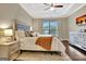 Stylish main bedroom with hardwood floors, a decorative tray ceiling, and modern furnishings at 609 Francis Ave, Peachtree City, GA 30269