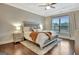 Serene main bedroom featuring a tray ceiling, plush bedding, and ample natural light at 609 Francis Ave, Peachtree City, GA 30269