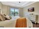 Comfortable main bedroom featuring an accent throw, hardwood floors, and a modern dresser at 609 Francis Ave, Peachtree City, GA 30269