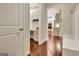 Hallway view of a built-in office nook and view to the Kitchen, with rich hardwood floors at 609 Francis Ave, Peachtree City, GA 30269