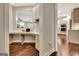 Built-in home office nook with open floor plan view of the kitchen, hardwood floors, and natural light at 609 Francis Ave, Peachtree City, GA 30269