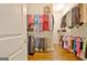 Walk-in closet with hanging clothes on racks and shelving at 609 Francis Ave, Peachtree City, GA 30269
