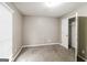 Bedroom with neutral carpet, window, and closet with a white door at 149 Camden Woods Pl, Dallas, GA 30157