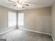 Bedroom featuring neutral walls and carpet with a ceiling fan and two windows at 149 Camden Woods Pl, Dallas, GA 30157