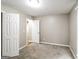 Bedroom with neutral carpet and walls featuring an open door to another room at 149 Camden Woods Pl, Dallas, GA 30157