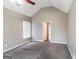 Bedroom with neutral walls, vaulted ceiling, a ceiling fan and carpet, creating a serene retreat at 149 Camden Woods Pl, Dallas, GA 30157