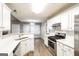 Modern kitchen with white cabinets, stainless steel appliances, and sleek countertops for a contemporary feel at 149 Camden Woods Pl, Dallas, GA 30157