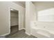 Bathroom with soaking tub, large window, and separate door to the closet area at 3675 Arminto Dr, Ellenwood, GA 30294