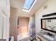Skylight bathroom features decorative shower curtain, tiled walls, granite countertop, and sink, offering comfort and style at 20 Rosser Rd, Mcdonough, GA 30252