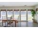 Bright dining area featuring a wooden table, white chairs, and multiple windows providing natural light at 20 Rosser Rd, Mcdonough, GA 30252