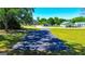 Long driveway offering ample parking, shaded by trees with a lush lawn and neighborhood view at 20 Rosser Rd, Mcdonough, GA 30252