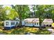 Exterior view of a one-story home with multiple windows and a cozy porch at 20 Rosser Rd, Mcdonough, GA 30252