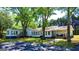 The home's exterior features a series of connected buildings, lots of windows, and a classic design, shaded by mature trees at 20 Rosser Rd, Mcdonough, GA 30252