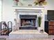 Close-up of the living room fireplace highlighting its mantel, tile work, and decorative elements at 20 Rosser Rd, Mcdonough, GA 30252
