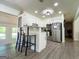 Bright updated kitchen with white cabinets, gray countertops, stainless appliances, and an island at 20 Rosser Rd, Mcdonough, GA 30252