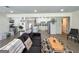 Bright living room with hardwood floors, comfy sectional, and views into the kitchen, offering an open layout at 20 Rosser Rd, Mcdonough, GA 30252