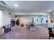 Spacious living room featuring a cozy fireplace, plush carpeting, and comfortable seating arrangement at 20 Rosser Rd, Mcdonough, GA 30252