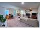Versatile living room with dedicated office space, a cozy fireplace, and ample natural light at 20 Rosser Rd, Mcdonough, GA 30252